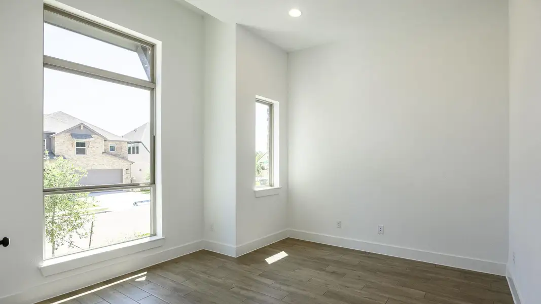 Unfurnished room featuring baseboards, recessed lighting, plenty of natural light, and dark wood-style floors Unfurnished room featuring baseboards, recessed lighting, plenty of natural light, and dark wood-style floors