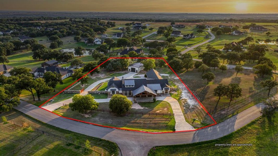 Expansive two-acre property outlined with fencing, showcasing the home’s impressive footprint and surrounding mature trees.