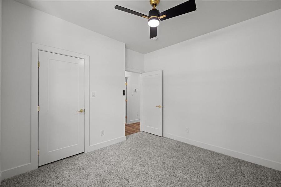 Unfurnished bedroom with carpet flooring and ceiling fan
