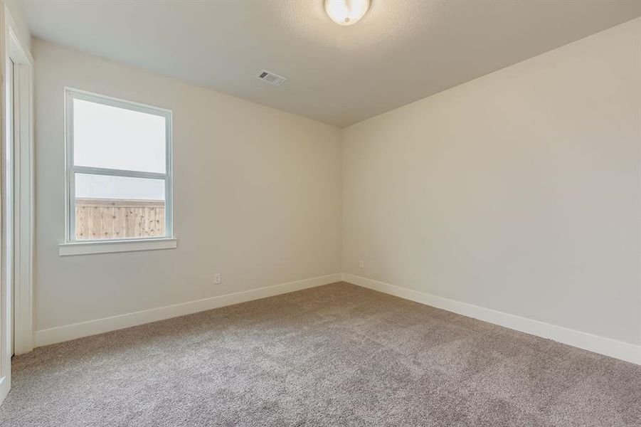 Spare room with carpet and baseboards