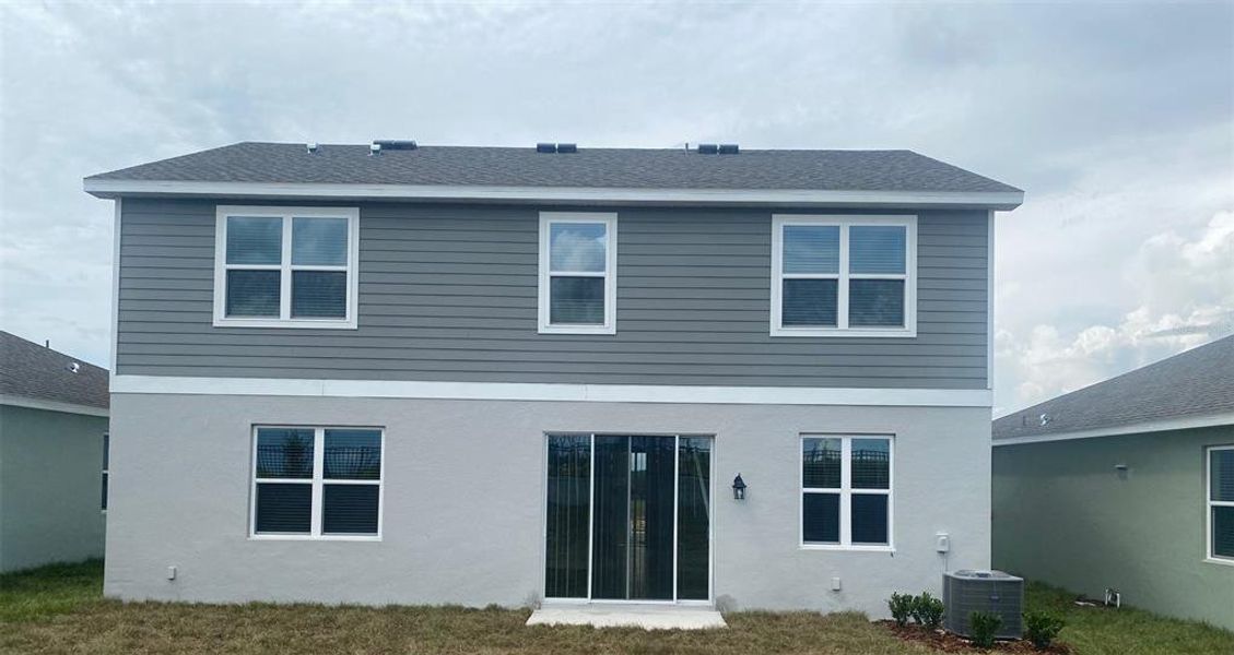 Front exterior of a new home in Hodges Reserve, Howey-in-the-Hills, FL, highlighting curb appeal (Image 1).