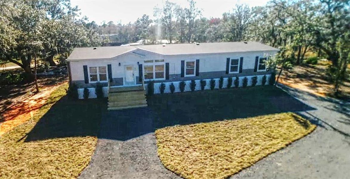Front exterior of a new home in , Frostproof, FL, highlighting curb appeal (Image 1). Front exterior of a new home in , Frostproof, FL, highlighting curb appeal (Image 1).