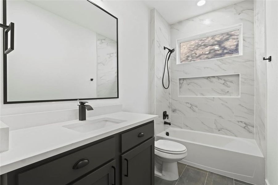 Bathroom featuring vanity and shower / tub combination Bathroom featuring vanity and shower / tub combination
