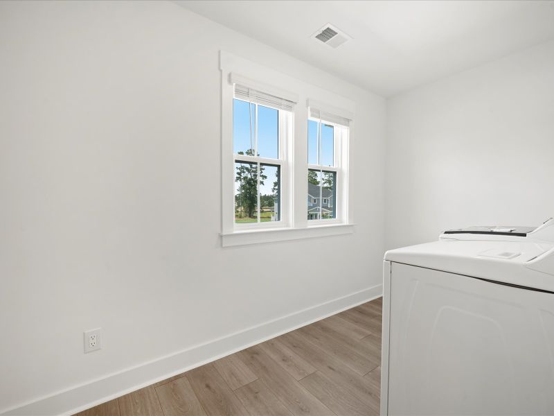Spacious, unfurnished interior of a new home in The Coves at Lakes of Cane Bay, Summerville (Image 39).