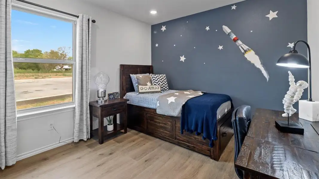 Bedroom featuring an accent wall, light wood-style floors, and recessed lighting Bedroom featuring an accent wall, light wood-style floors, and recessed lighting
