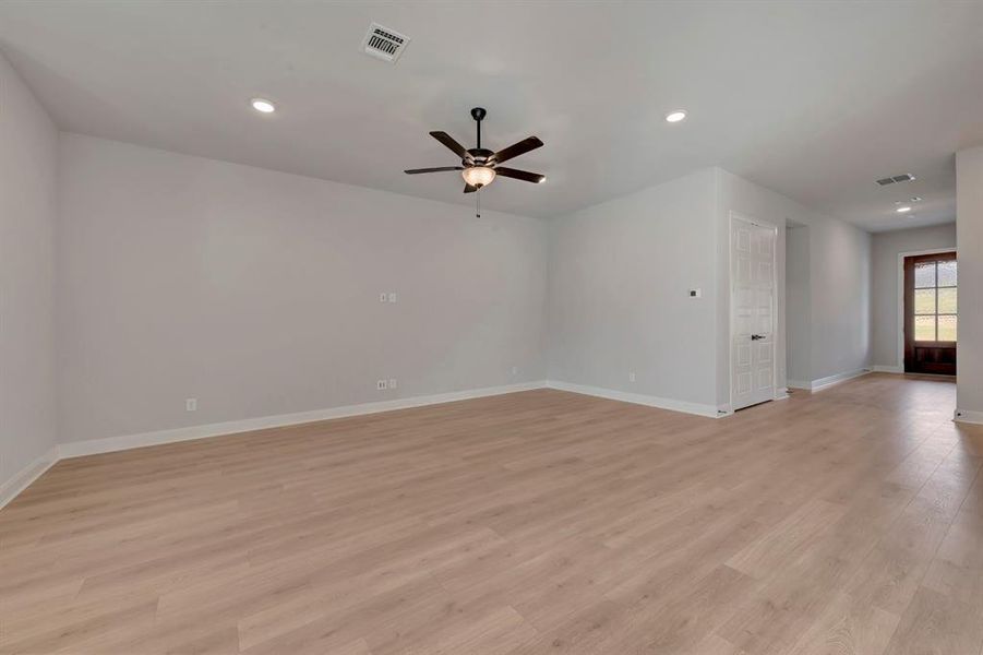 Empty room featuring recessed lighting, light wood-style flooring, and a ceiling fan