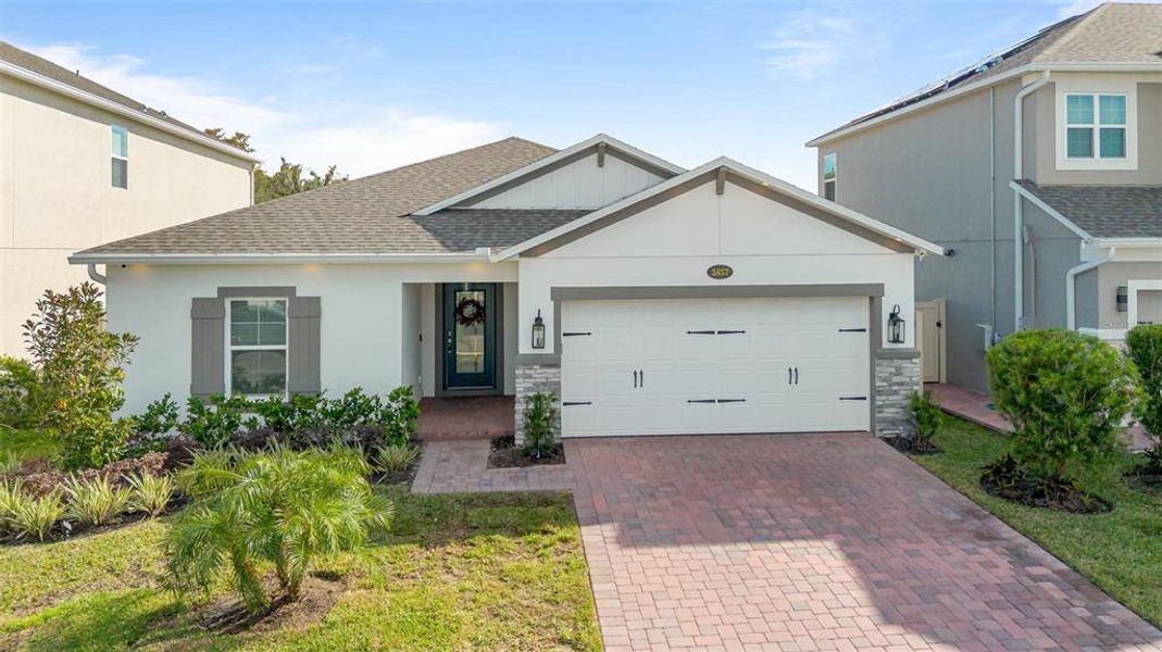 Front exterior of a new home in Eden at Crossprairie, St. Cloud, FL, highlighting curb appeal (Image 1). Front exterior of a new home in Eden at Crossprairie, St. Cloud, FL, highlighting curb appeal (Image 1).
