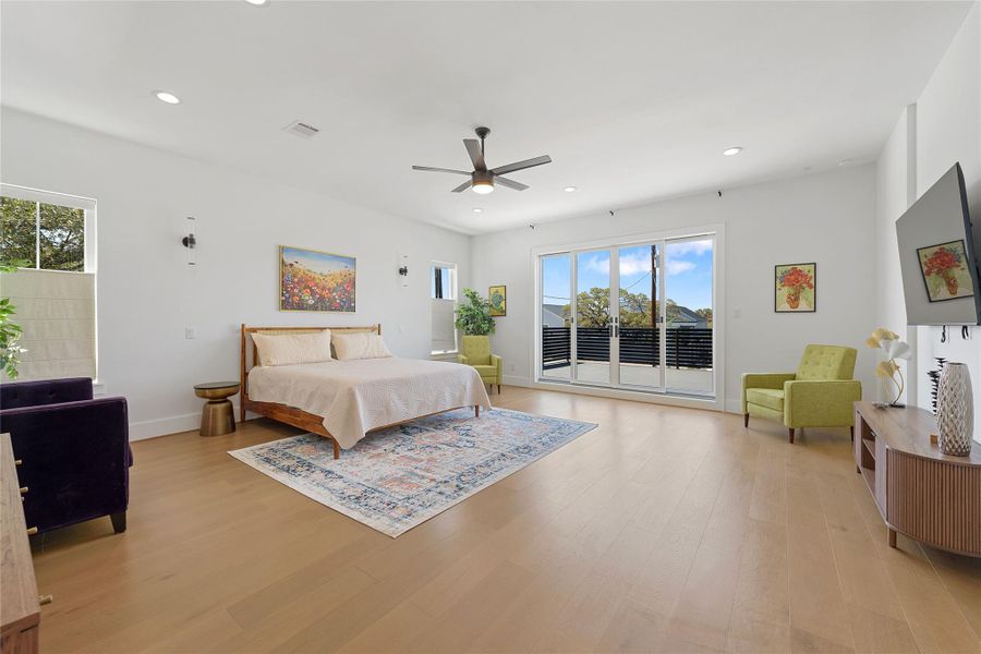 Wake up to sweeping views of Canyon Lake from this tranquil primary suite. Featuring sliding glass doors to a private balcony, warm wood floors, and a minimalist design—this space is your perfect Hill Country retreat.