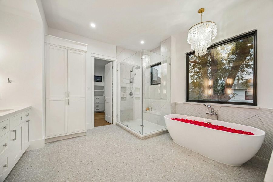 Another view of the Primary Bathroom with a large walk-in shower, frameless shower door, Brizo wall-mounted shower head and a Brizo Hand-held Shower.  There is a fantastic linen storage closet for toiletries, towels and more...