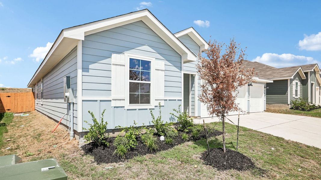 Front exterior of a new home in Prairie Lakes, Buda, TX, highlighting curb appeal (Image 2).