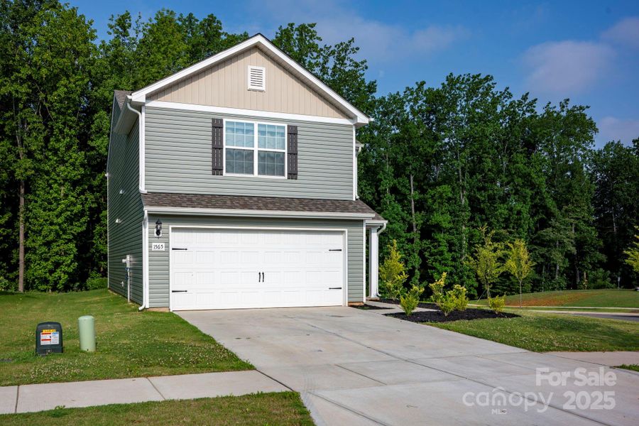 Front exterior of a new home in McKee Creek Village, Charlotte, NC, highlighting curb appeal (Image 2).