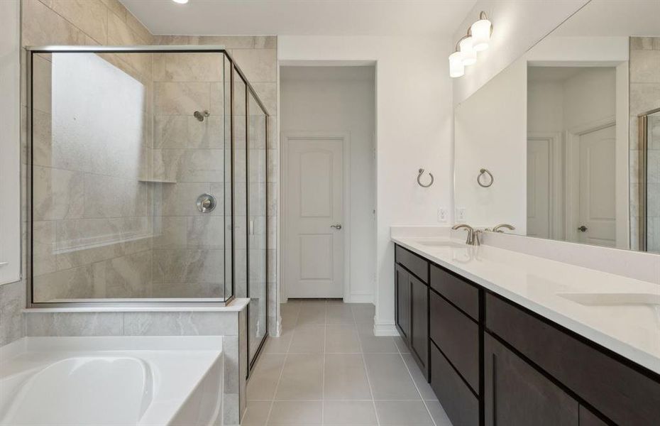 Elegant owner's bathroom with dual vanity *real home pictured