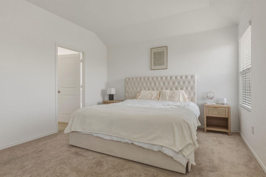 Bedroom featuring light-colored carpet flooring and white walls