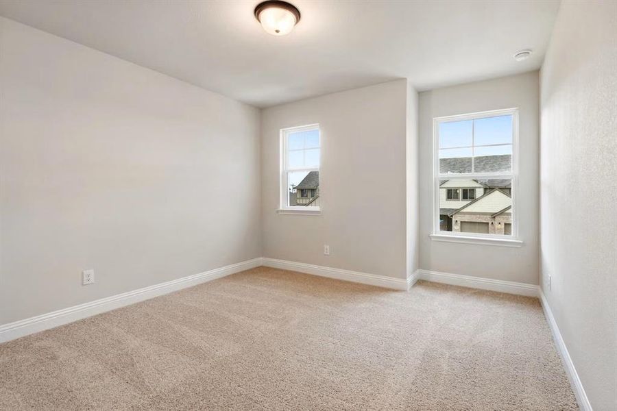 Spare room with a healthy amount of sunlight and light colored carpet