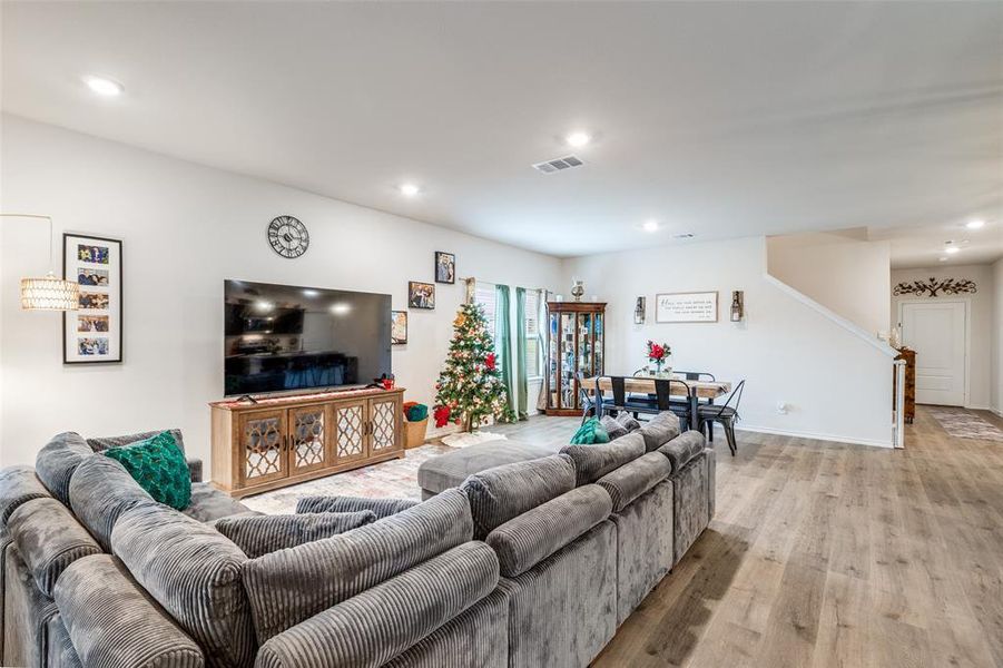 Living room featuring wood finished floors and recessed lighting Living room featuring wood finished floors and recessed lighting