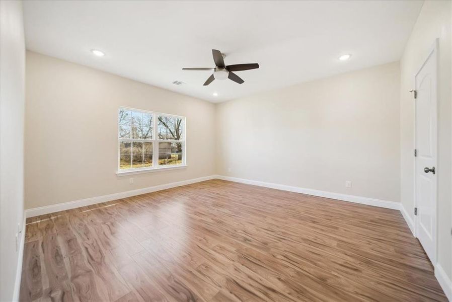 Spare room featuring light wood-type flooring and ceiling fan