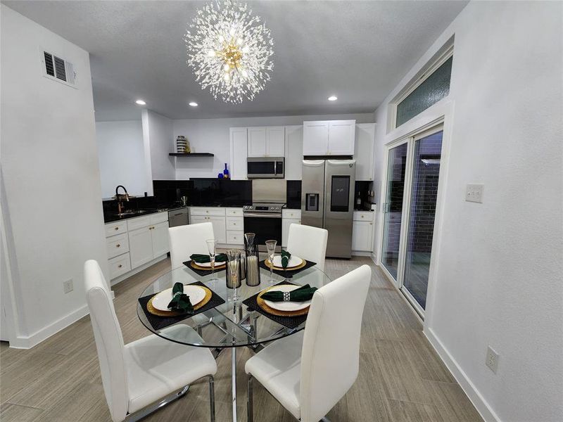 Dining room featuring sink and a chandelier