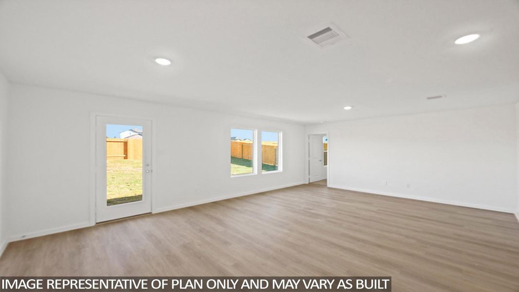 Empty room with light wood-style floors, healthy amount of natural light, and recessed lighting