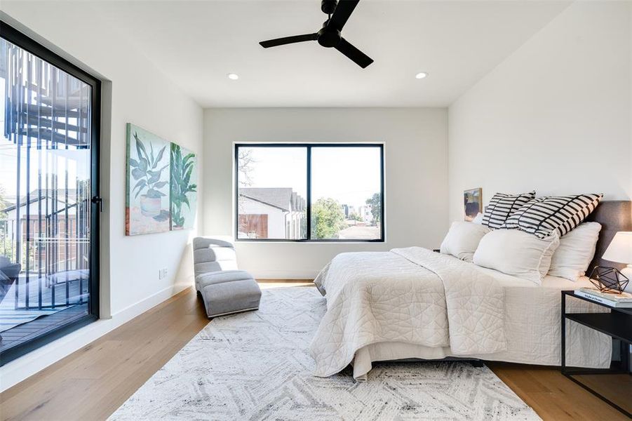 Bedroom with ceiling fan, access to exterior, and hardwood / wood-style floors