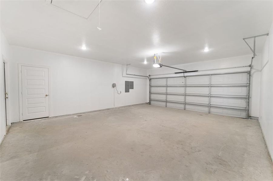 Garage with a garage door opener and electric panel