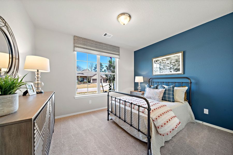 A bedroom with a bed and a desk. A bedroom with a bed and a desk.