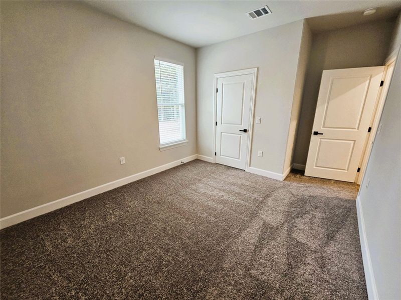 Unfurnished bedroom featuring baseboards and carpet flooring