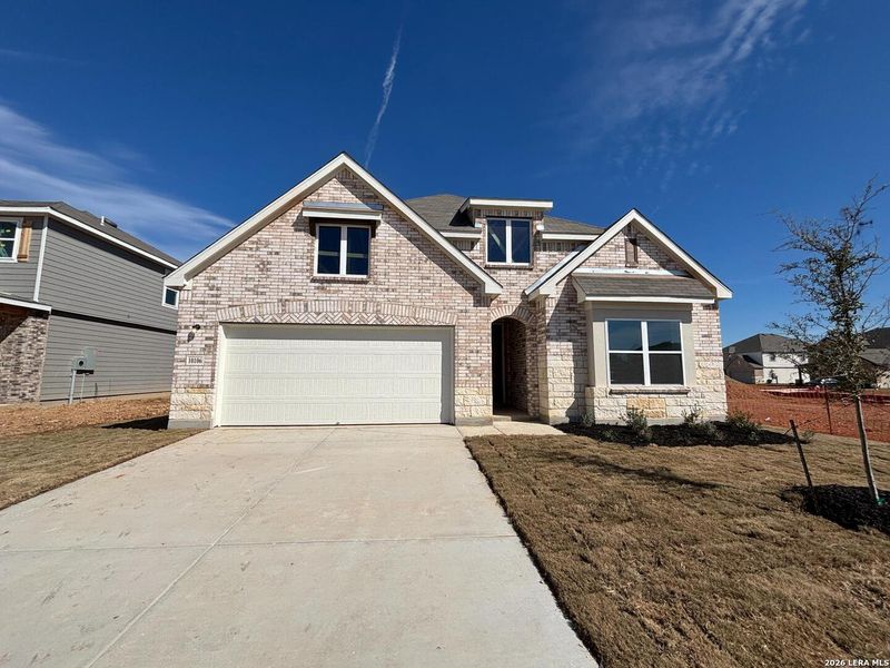 Front exterior of a new home in Saddlebrook Ranch, Schertz, TX, highlighting curb appeal (Image 2). Front exterior of a new home in Saddlebrook Ranch, Schertz, TX, highlighting curb appeal (Image 2).