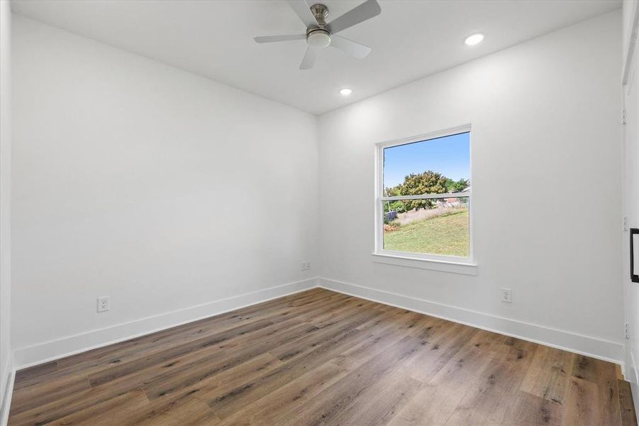 Empty room featuring ceiling fan and luxury vinyl flooring