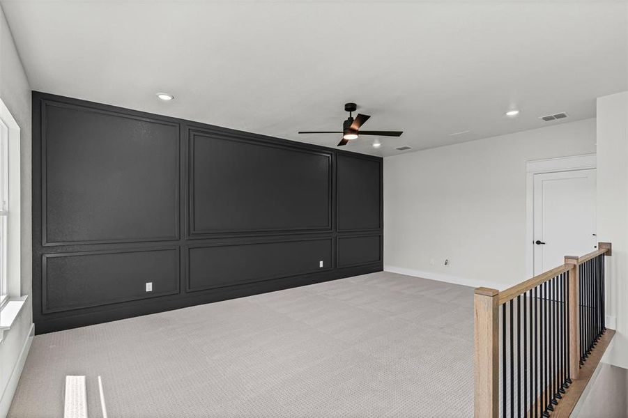 Unfurnished bedroom featuring a ceiling fan, light carpet, a decorative wall, and recessed lighting Unfurnished bedroom featuring a ceiling fan, light carpet, a decorative wall, and recessed lighting