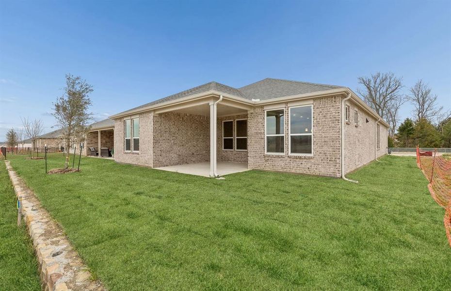 Back of home with covered patio