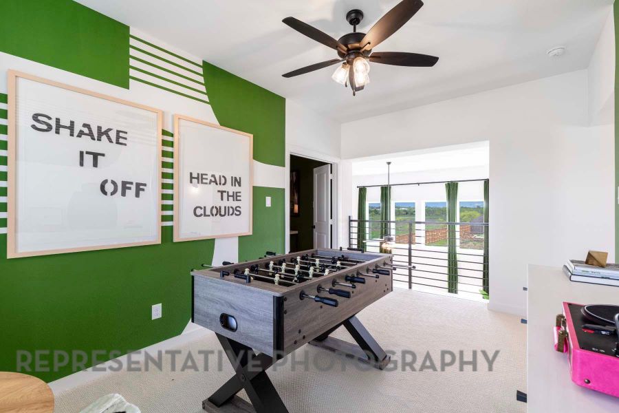 Recreation room featuring a ceiling fan and carpet flooring Recreation room featuring a ceiling fan and carpet flooring