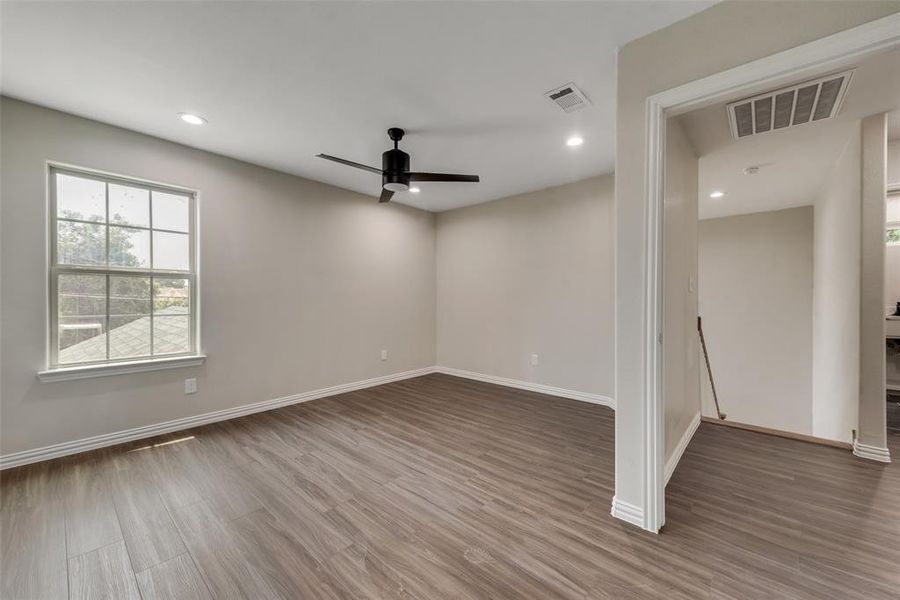 Unfurnished room with ceiling fan and hardwood / wood-style floors