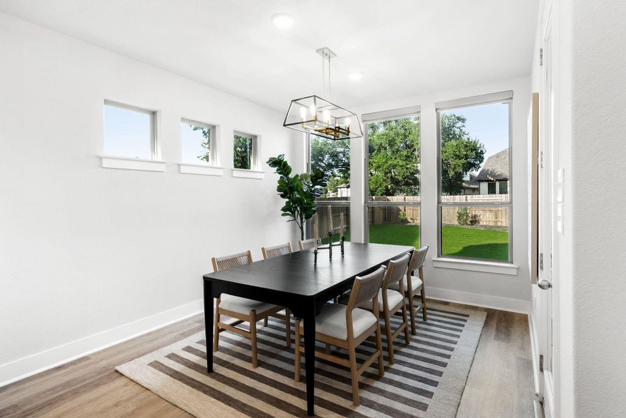 Bright dining area with ample natural illumination and backyard views.