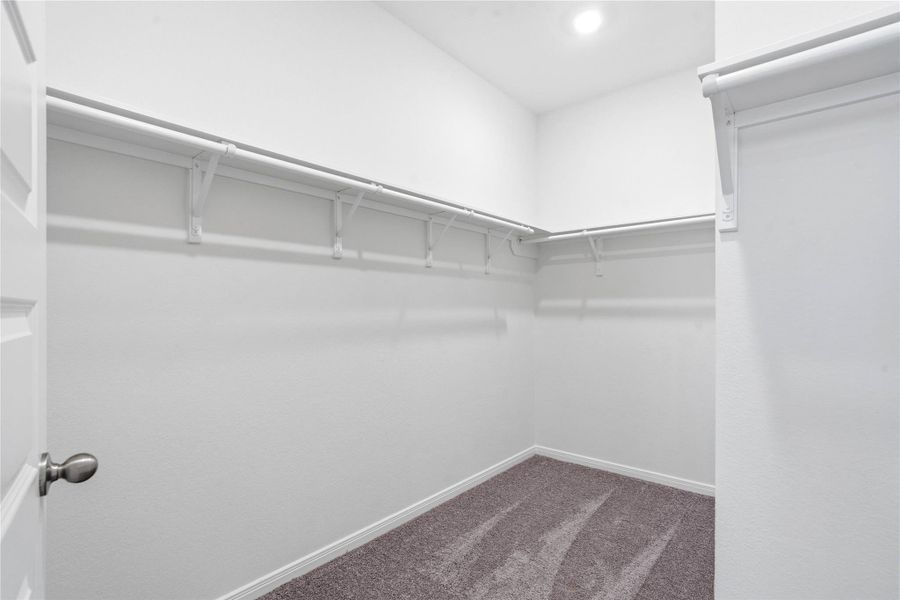 Experience the convenience of a spacious walk-in closet designed to simplify your morning routine. There is plenty of room to keep your wardrobe organized and easily accessible. Experience the convenience of a spacious walk-in closet designed to simplify your morning routine. There is plenty of room to keep your wardrobe organized and easily accessible.