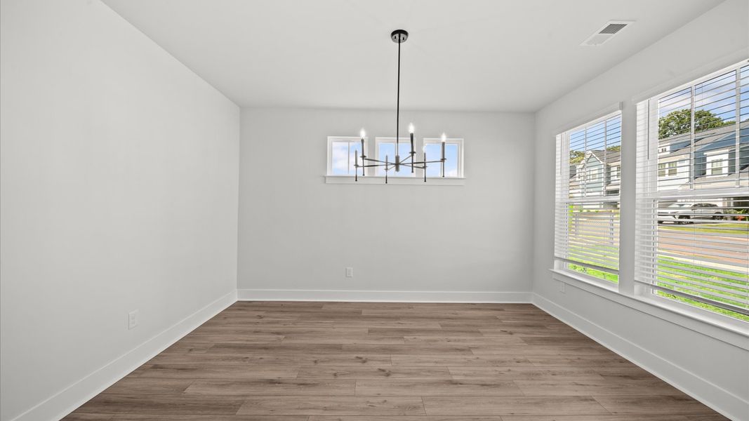 Open-concept dining area with thoughtful flow perfect for entertaining in this first-class townhome