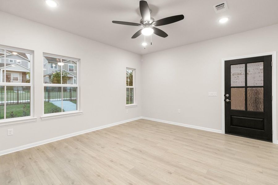 This room features light-colored flooring, white walls, and recessed lighting