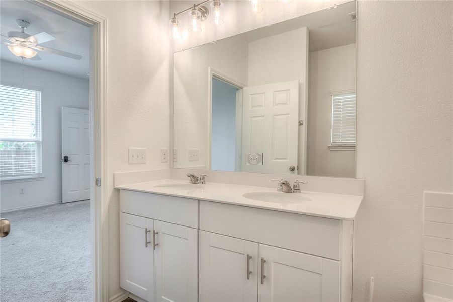 Full bath featuring double vanity, garden tub, separate shower and luxury vinyl plank flooring. Full bath featuring double vanity, garden tub, separate shower and luxury vinyl plank flooring.