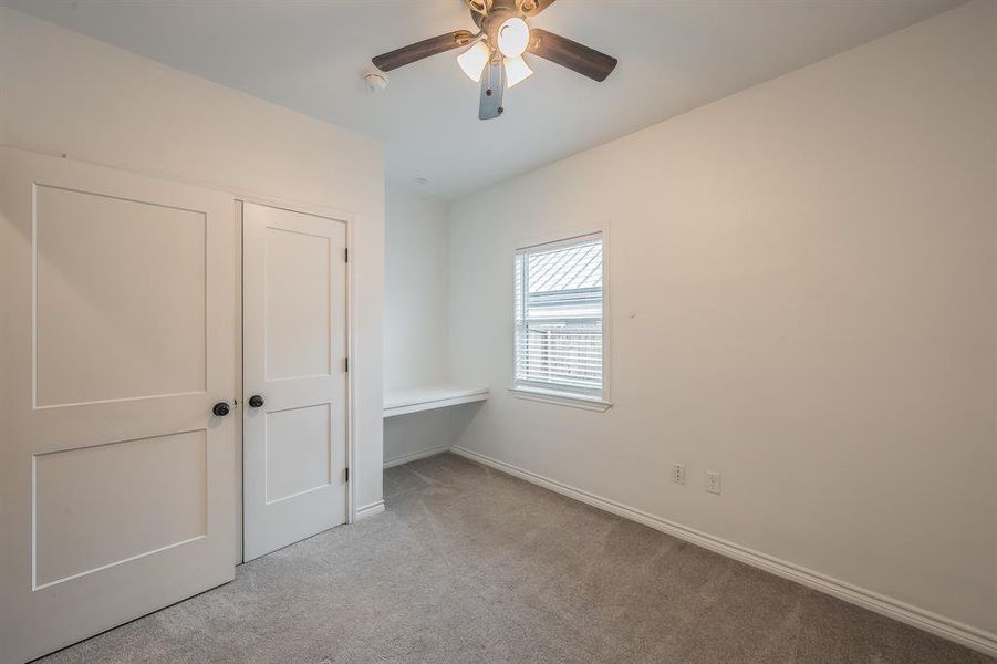 Unfurnished bedroom featuring carpet floors and ceiling fan Unfurnished bedroom featuring carpet floors and ceiling fan