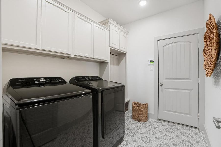 Washroom with cabinet space, washer and dryer, and recessed lighting Washroom with cabinet space, washer and dryer, and recessed lighting