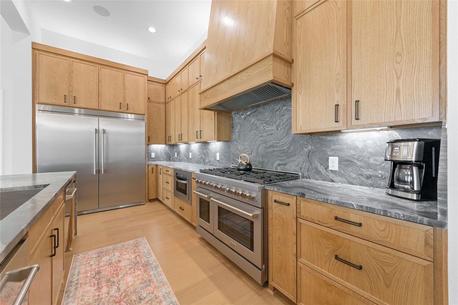 Double dishwasher, 60'' fridge/freezer, 60" gas stove, and an abundance of counterspace.