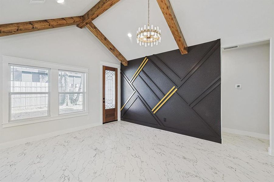 Entrance foyer featuring vaulted ceiling with beams and a chandelier