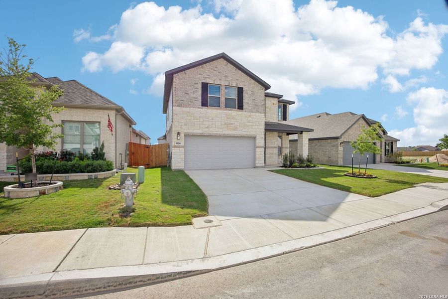 Front exterior of a new home in Kallison Ranch, San Antonio, TX, highlighting curb appeal (Image 26). Front exterior of a new home in Kallison Ranch, San Antonio, TX, highlighting curb appeal (Image 26).