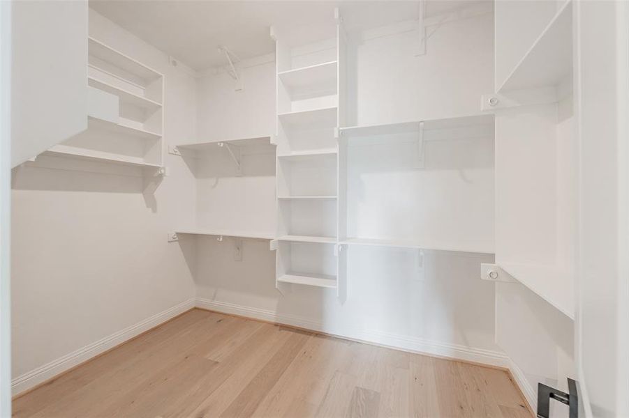 Primary bedroom equipped with built in shelving