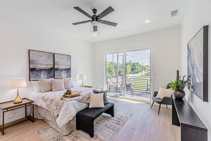 Bedroom with access to outside, light wood-style flooring, a ceiling fan, and recessed lighting Bedroom with access to outside, light wood-style flooring, a ceiling fan, and recessed lighting