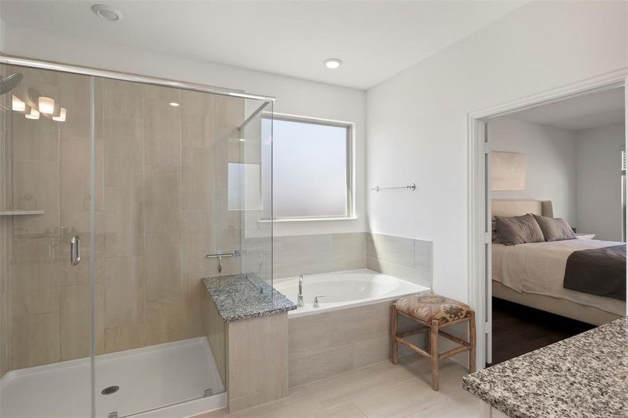 Primary Bathroom w/ separate vanities, walk in shower and separate tub