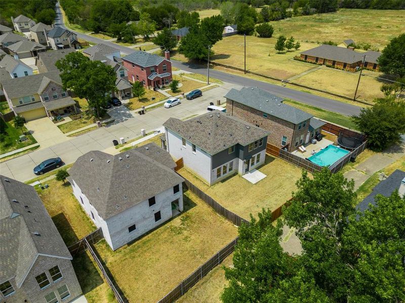 Aerial perspective of suburban area featuring a pool Aerial perspective of suburban area featuring a pool