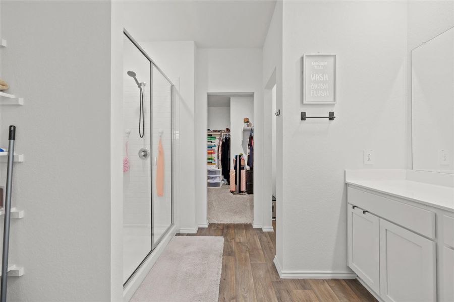 Storage meets style! This beautifully appointed bathroom offers seamless access to a walk-in closet, ensuring all your wardrobe essentials are organized and right at your fingertips.