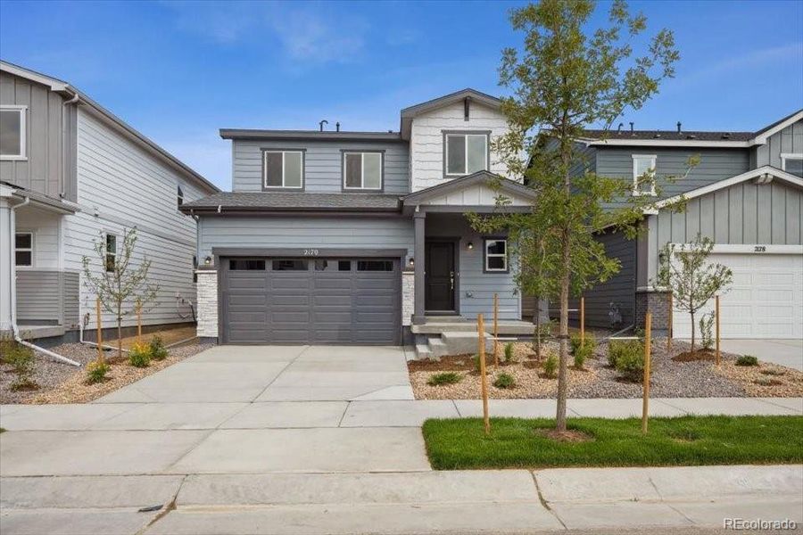 Front exterior of a new home in Farmlore, Brighton, CO, highlighting curb appeal (Image 2).