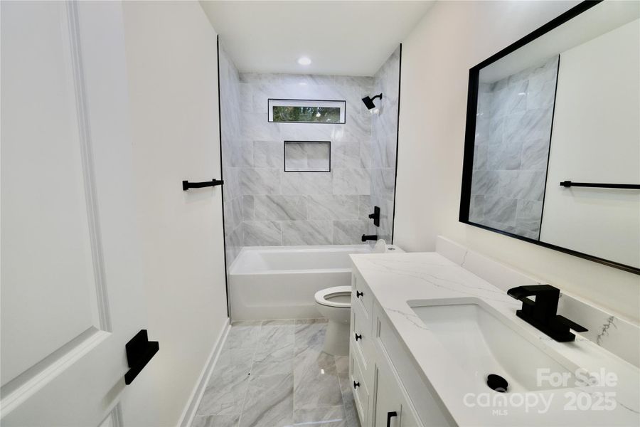 Spare full bathroom w/ tile floor & shower Spare full bathroom w/ tile floor & shower