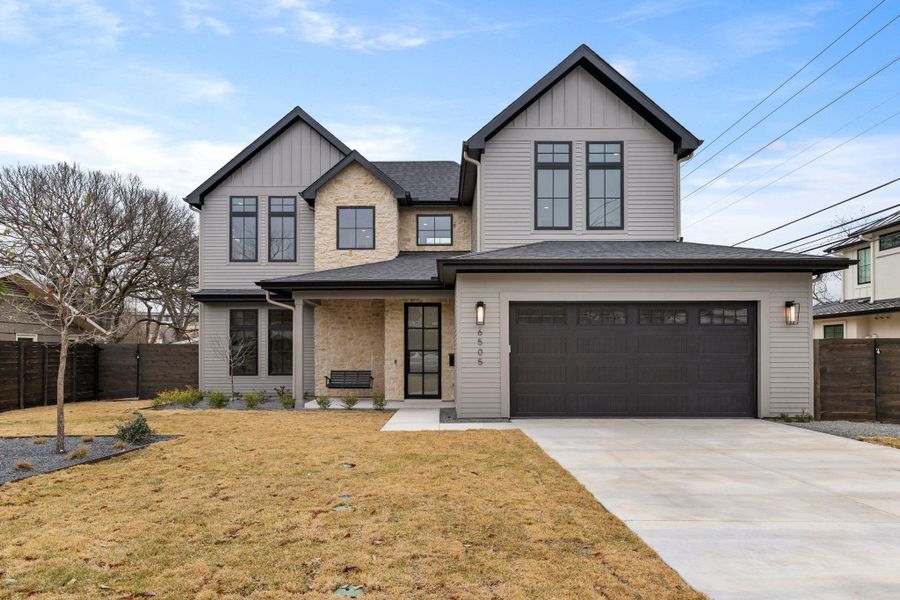 View of front of home featuring board and batten siding, a garage, driveway, and a shingled roof